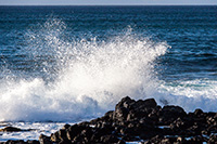 Wave crashing on the rocks at Papahaku Beach