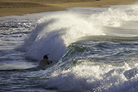 Classmate in a breaking wave at Papahaku Beach